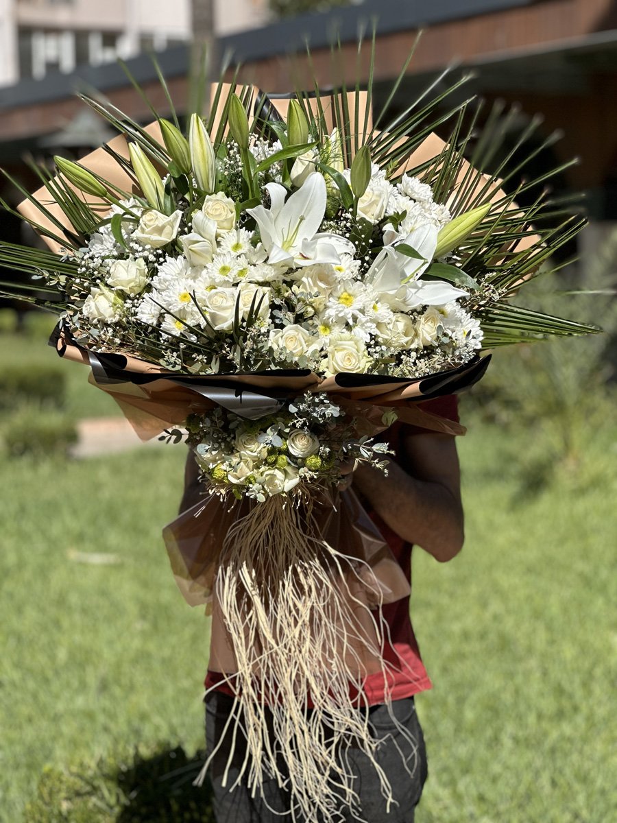 Adana beyaz lilyum gül papatya buketi, kahverengi kraft kağıtlı ve önü minik gül süslemeli doğal tasarım.