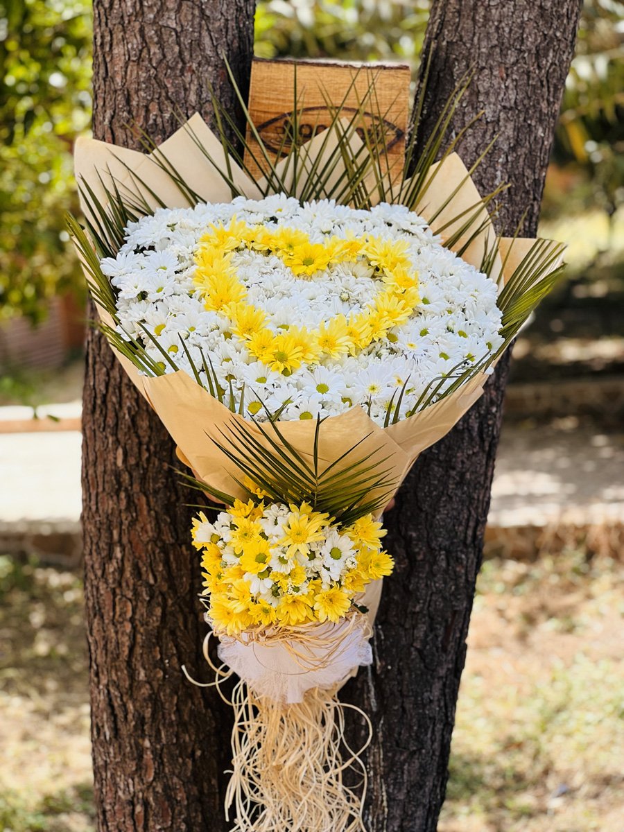 Adana kalpli papatya buketi, beyaz papatyalar ortasında sarı papatyadan kalp şekli.